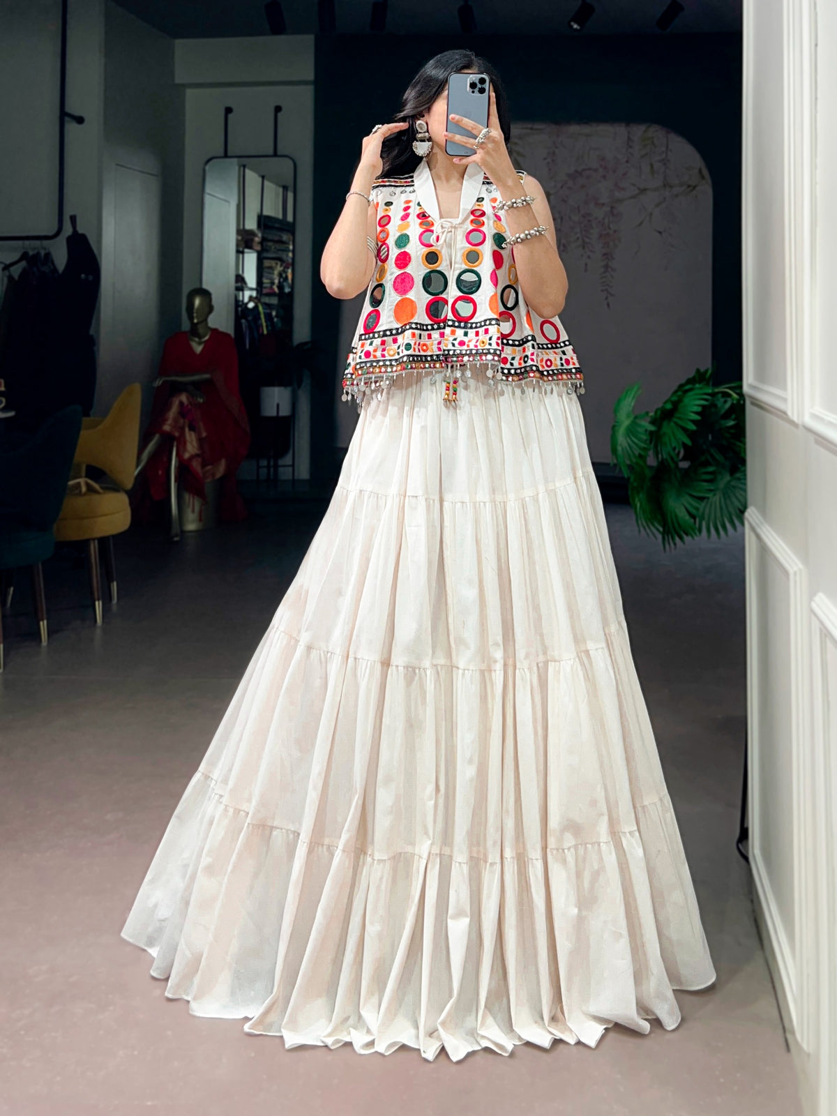 The sparkle of mirrors, a swirling lehenga, and the tunes of Garba—combined with traditional mirror-work detailing, these elements create a stunning festive look that looks beautiful for Navratri celebrations.