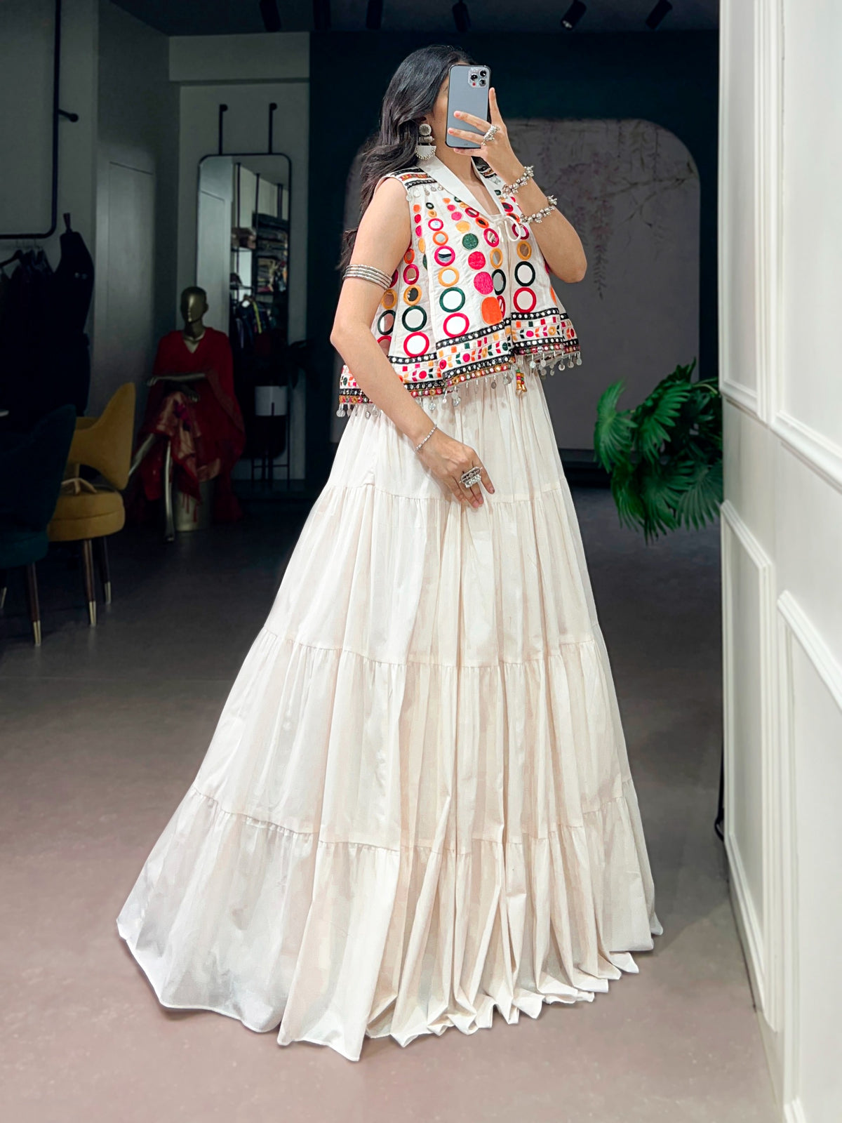 The sparkle of mirrors, a swirling lehenga, and the tunes of Garba—combined with traditional mirror-work detailing, these elements create a stunning festive look that looks beautiful for Navratri celebrations.