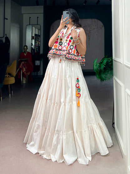 The sparkle of mirrors, a swirling lehenga, and the tunes of Garba—combined with traditional mirror-work detailing, these elements create a stunning festive look that looks beautiful for Navratri celebrations.