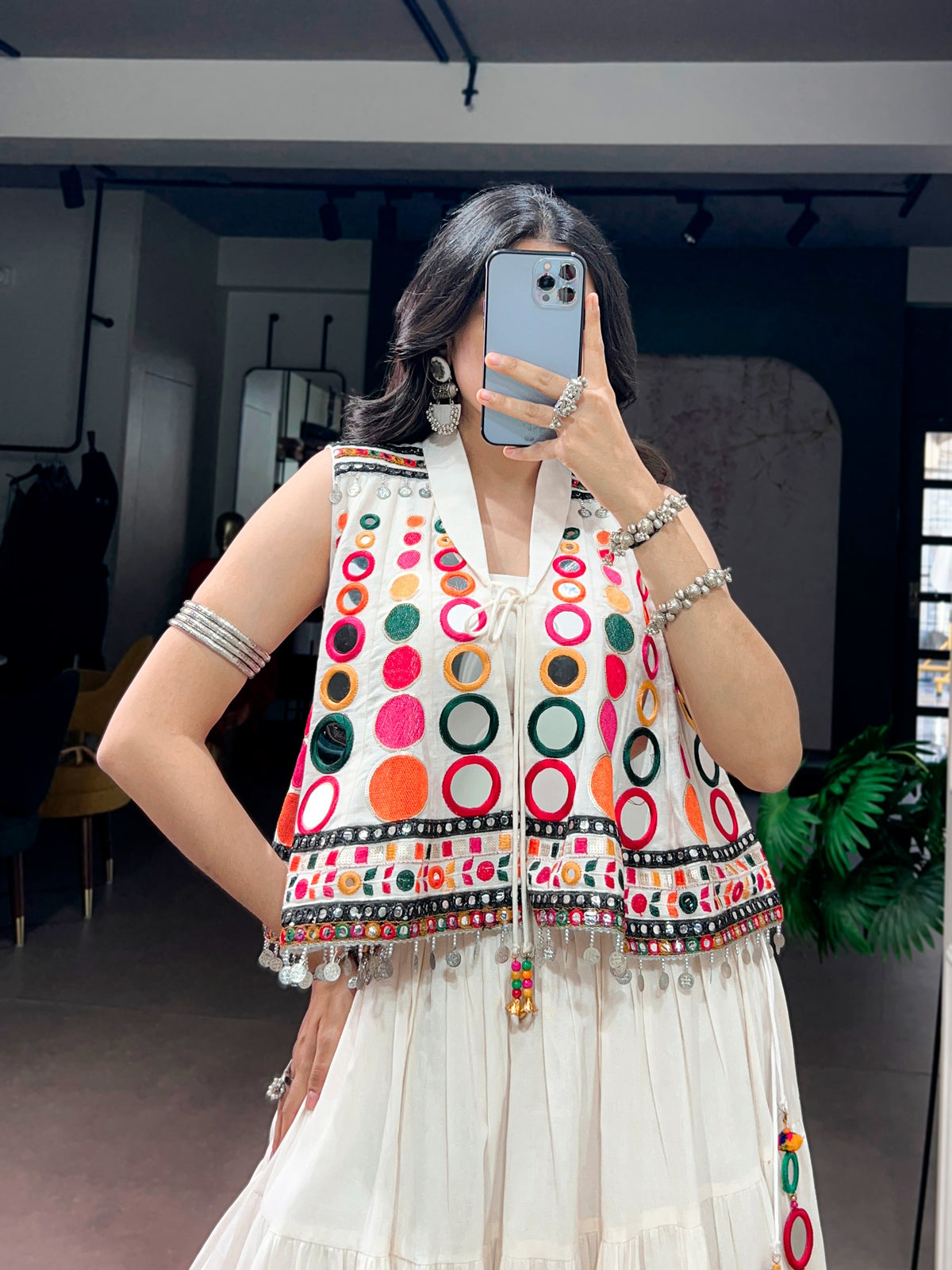 The sparkle of mirrors, a swirling lehenga, and the tunes of Garba—combined with traditional mirror-work detailing, these elements create a stunning festive look that looks beautiful for Navratri celebrations.