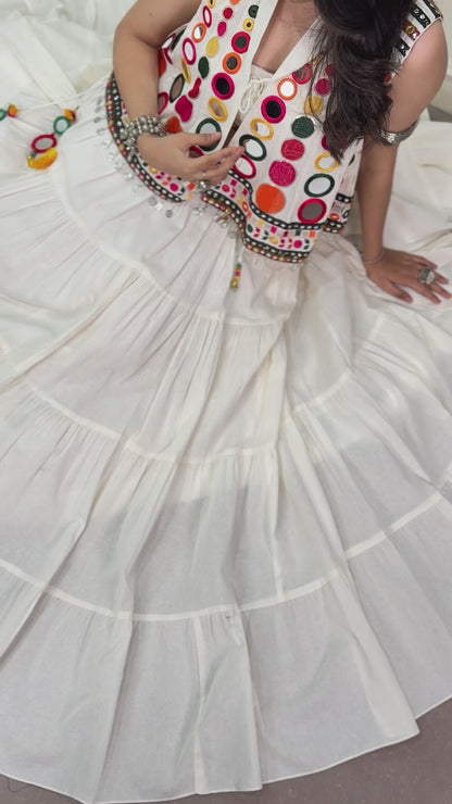 The sparkle of mirrors, a swirling lehenga, and the tunes of Garba—combined with traditional mirror-work detailing, these elements create a stunning festive look that looks beautiful for Navratri celebrations.